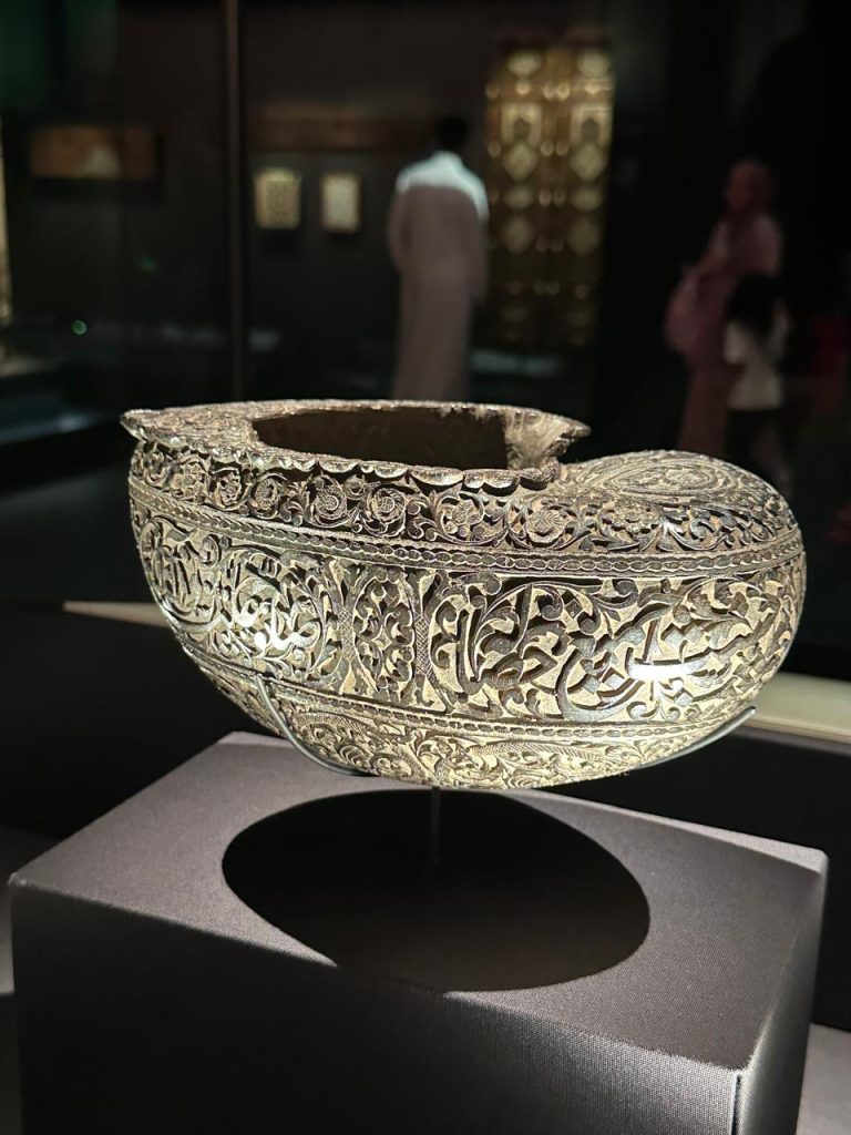 Ornate silver vessel with Arabic calligraphy and intricate patterns, transforming utility into art