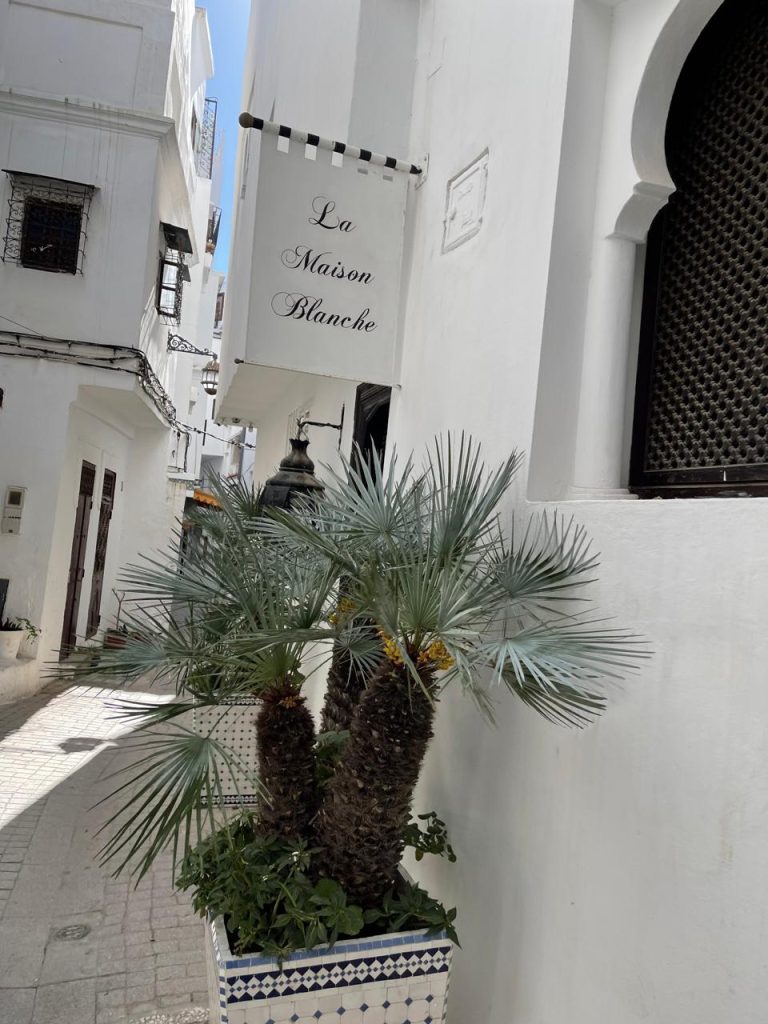Boutique hotel façade with Arabic-inspired arches and intricate details, showcasing regional craftsmanship.
