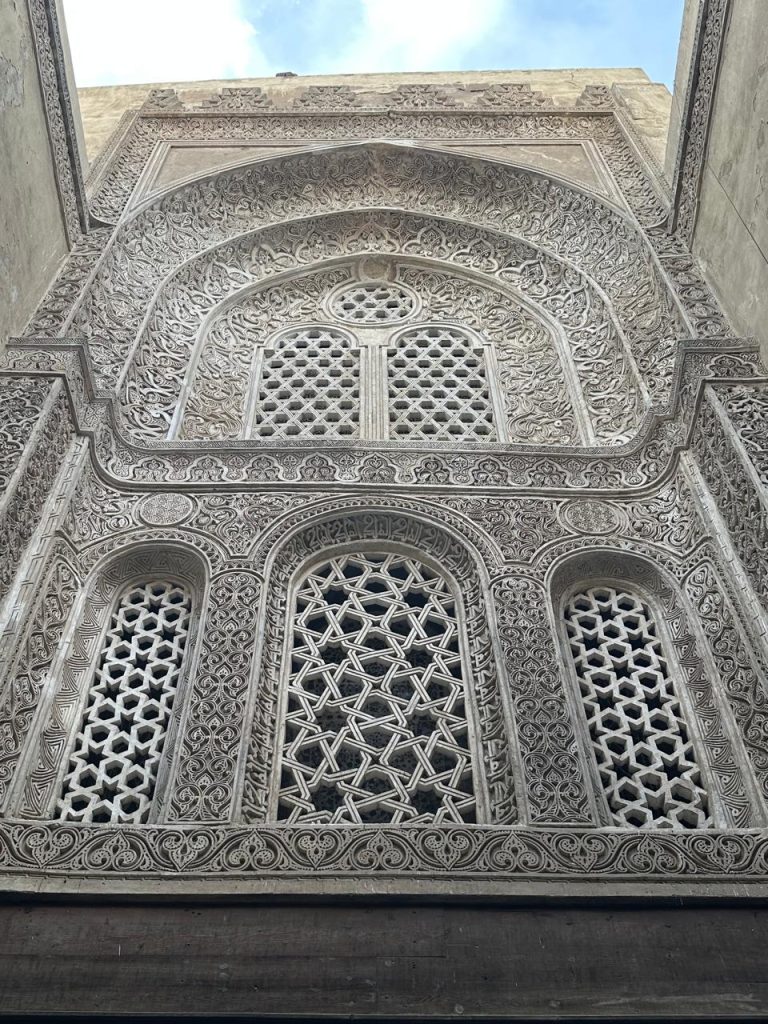 Historic stone facade showcasing intricate Arabic carvings and craftsmanship