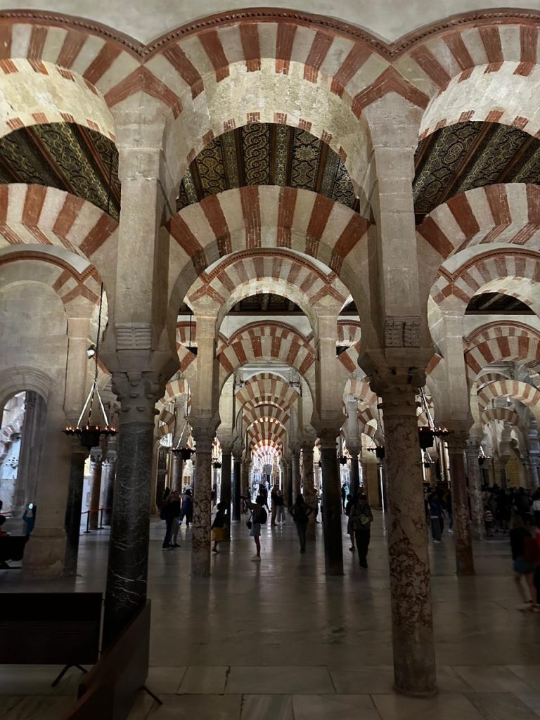 View of Córdoba’s historic Islamic architecture, highlighting stone arches and ornamental details.