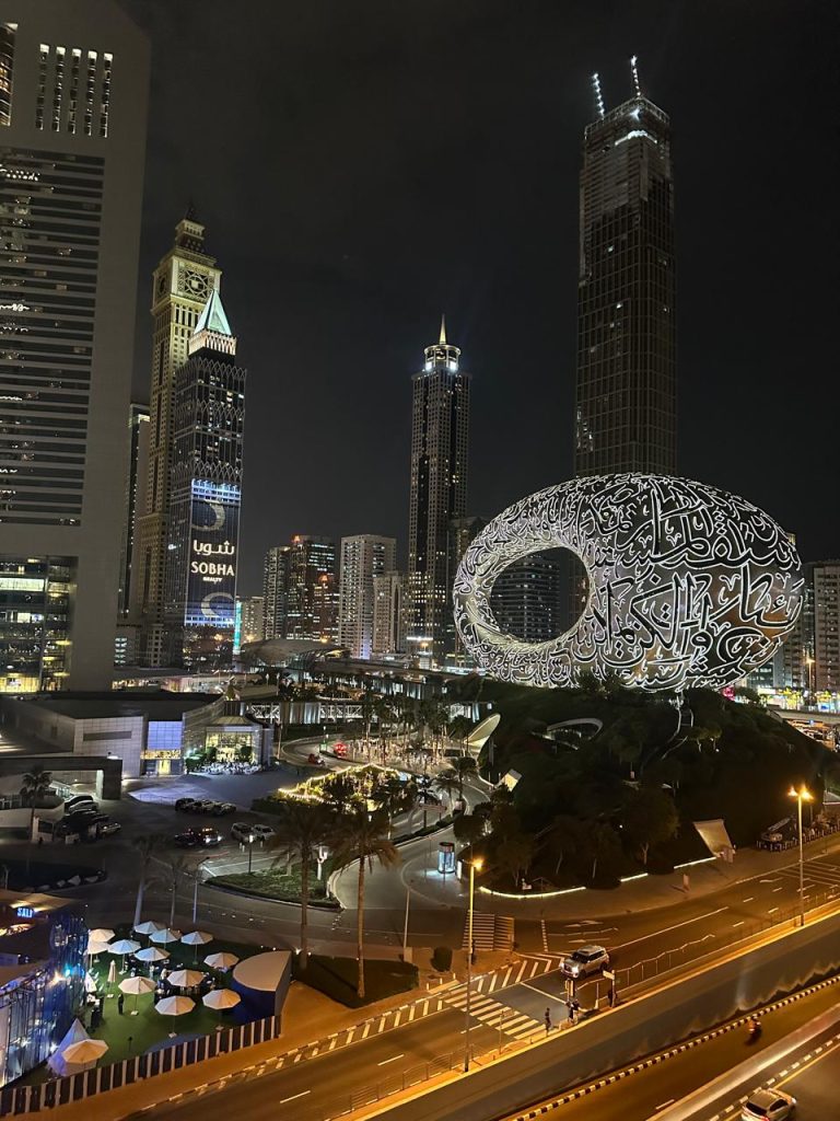 Night view of Dubai’s Museum of the Future with illuminated Arabic calligraphy facade.