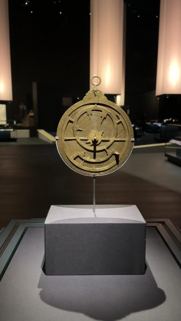 Ancient brass astrolabe displayed in a museum, representing Islamic contributions to science.