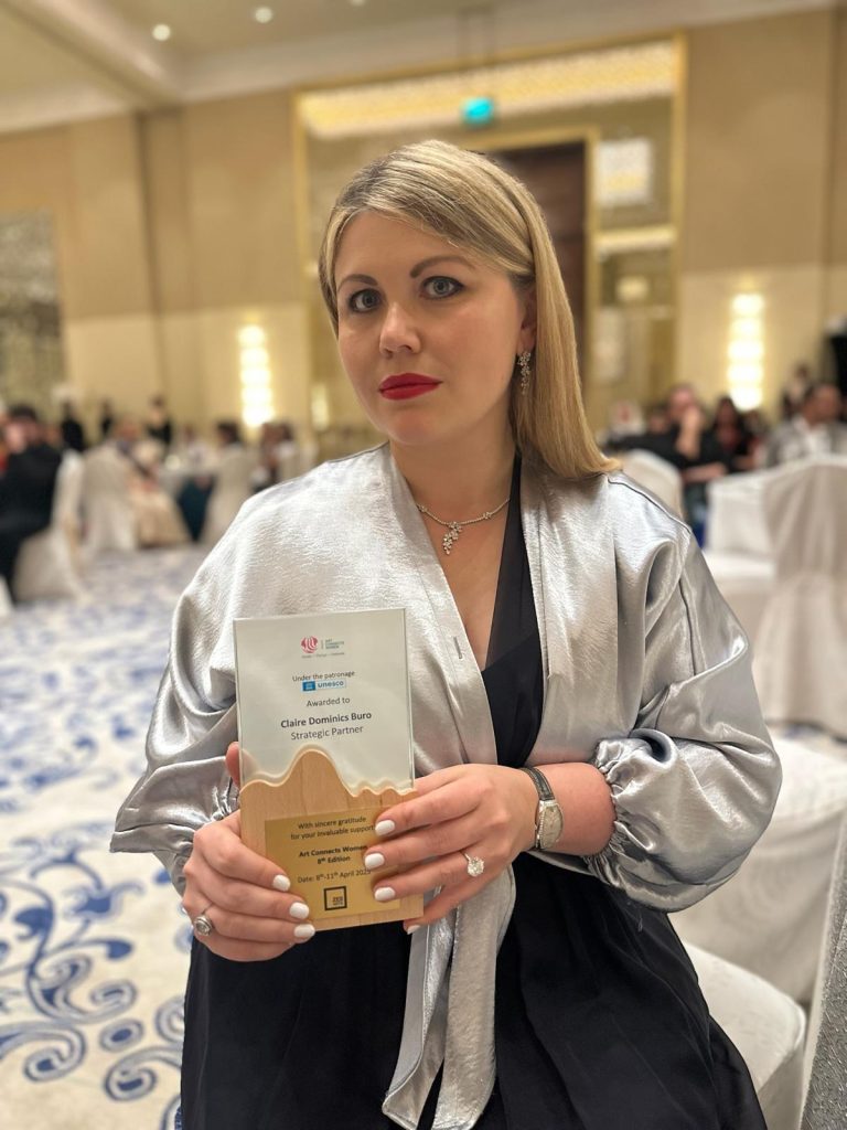 Claire Ordovsky Tanaevsky holding the Strategic Partner Award at the Art Connects Women 2025 Gala in Dubai.
