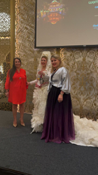 Claire with artist from Spain on stage presenting award at Art Connects Women closing event
