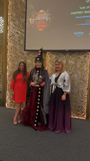 Claire presenting award to participant from Kazakhstan at the Royal Ballroom ceremony
