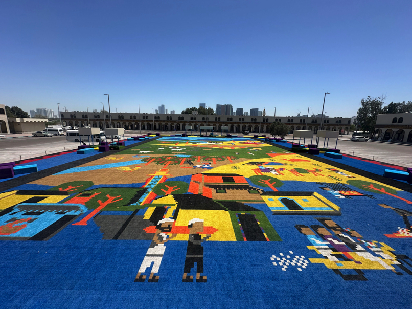 Large-scale floor mural at Abu Dhabi Biennale — community art zone